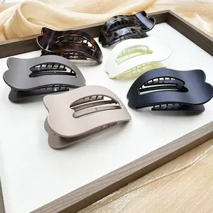 Detailed view of assorted heart-shaped hair claws in tortoiseshell and marble finishes