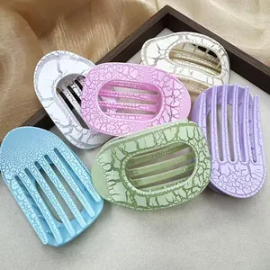Flat oval hair claw clips with marble crack pattern in various pastel colors