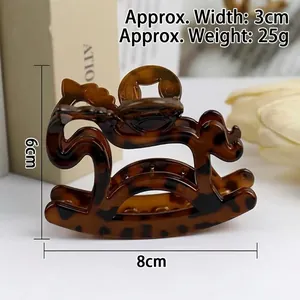 Detailed view of horse-shaped hair claw clip with dimensions 8cm by 6cm in tortoise shell