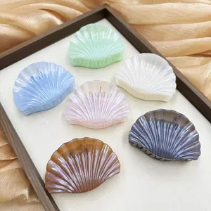 Detail of shell hair clips with pearlescent finish in six soft pastel colors