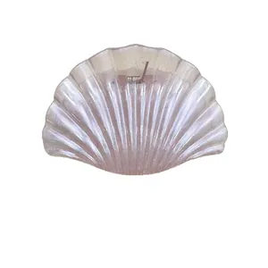 Pink pearlescent shell hair claw clip with shimmering jelly finish for summer beach styling