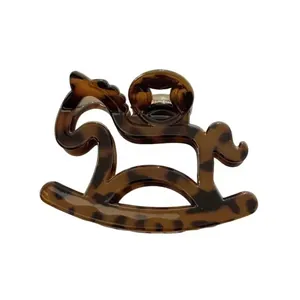Minimalist horse-shaped hair claw clip with classic tortoiseshell pattern and cutout design