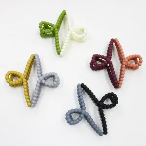Detail of matte dual-color claw clips with unique bead texture in various color palettes