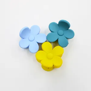 Three matte floral hair claws in sky blue, peacock green, and bright yellow colors