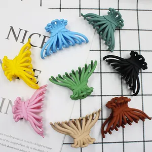 Matte candy colored bow hair claws in various shades on a white textured background
