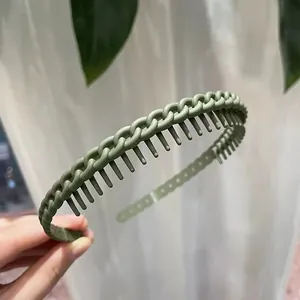 Close-up of matte green headband with non-slip comb teeth and chain link texture