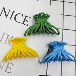 Frosted candy-colored large hair claws in green, yellow, and blue resin with matte finish