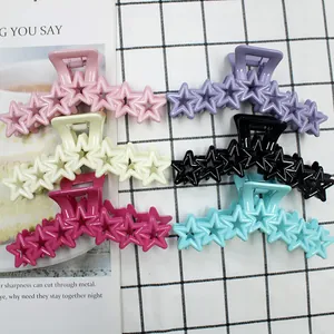 Detailed top view of colorful star-shaped hair claws in six vibrant macaron shades