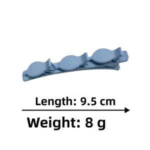 Macro detail of a 9.5cm light blue matte three-section hair clip for daily styling