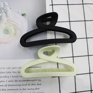 Detail of matte hair claws in black and light green with anti-slip grip design