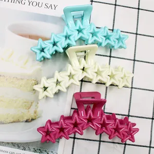 Star-shaped matte claw clips in pastel blue, cream white, and bright rose red