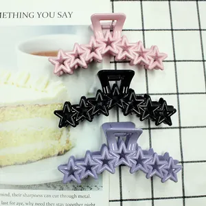 Star-shaped cutout hair clips in macaron pink, black, and purple for women