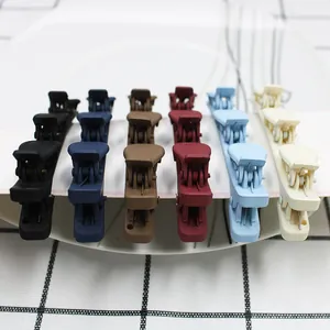 Set of six colorful matte duckbill hair clips neatly arranged on a white edge