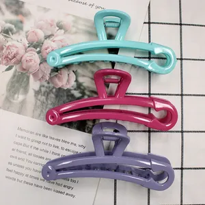 Three-piece set of colorful safety pin style hair claws in teal, magenta, and purple colors