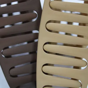 Detail showing matte finish large hollow hair claw clips in coffee and khaki colors