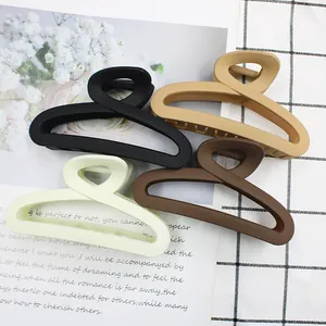 Set of four matte hollow claw clips in black, khaki, green, and coffee for hair styling