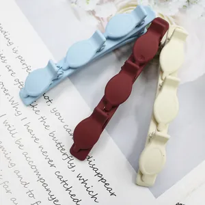 Three colorful matte multi-layer hair clips for braided styling in blue, red, and beige