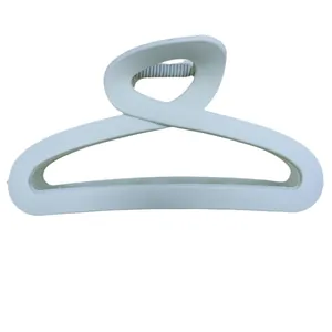 Minimalist matte cream claw clip with hollow cross design for elegant hair styling