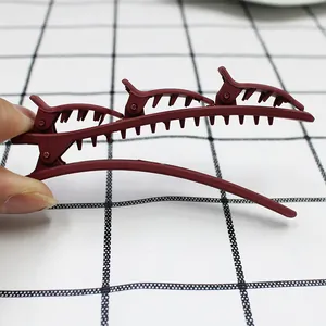 Detailed macro view of wine red matte layered hair clip with secure double grip design