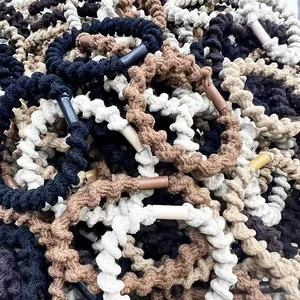 Neutral woven telephone wire hair ties in black, beige and coffee colors pile view