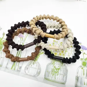 Detailed view of elastic spiral hair ties in natural tones with woven fabric texture