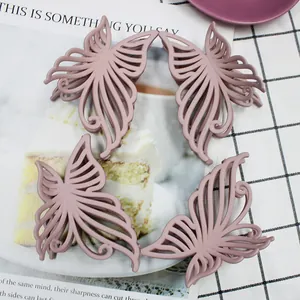 Close-up of four 10cm matte hollow butterfly hair claws in Morandi dusty pink tones
