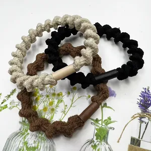 Three elastic spiral hair ties in cream, black and coffee colors with floral props
