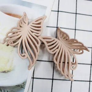 Detailed close-up of 10cm matte butterfly hair claws in elegant cream beige tones