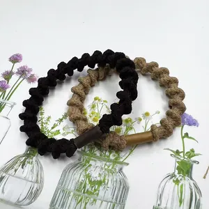 Braided spiral telephone wire hair ties in black and khaki colors with a sleek finish