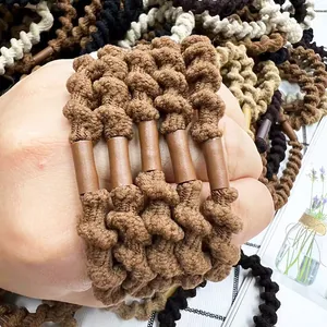 Close-up of elastic spiral hair ties in various colors worn on wrist as bracelets