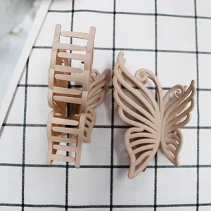 Detailed macro view of a 10cm matte nude hollow butterfly hair claw clip for women