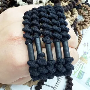 Close-up of elastic spiral hair ties with woven fabric texture worn on a wrist