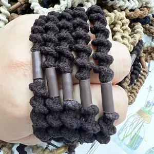 Close-up of flexible spiral braided hair ties in brown and neutral earthy tones