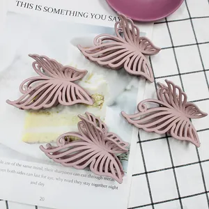 Detail of 10cm matte pink butterfly hair claw clips with hollow design and metal spring