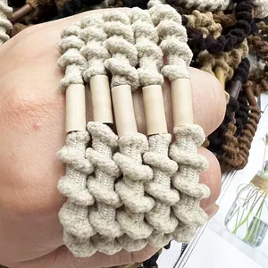 Macro shot of spiral woven elastic hair ties in neutral tones with white tube buckle detail