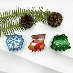 Detailed view of Christmas hair clips featuring blue snowflake red sock and green tree designs
