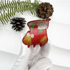 Detail of Christmas stocking hair claw clip with colorful glitter and resin finish