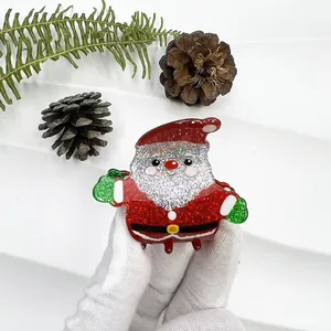 Detail of glittery Santa Claus hair claw clip with festive red and green sequins