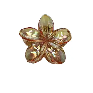 Iridescent gold frangipani flower hair claw clip with colorful metallic finish