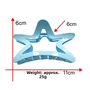 Detail view of light blue star-shaped shark hair clip with 11cm width and 6cm height measurements
