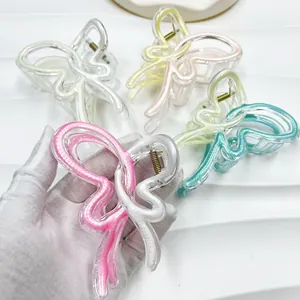 Detail view of colorful butterfly hair claws in translucent acrylic with metal spring