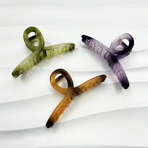 Close-up of 13cm matte hair claws in olive green, gradient purple and amber colors