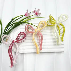 Detailed set of three colorful resin bow hair claws with durable golden metal springs