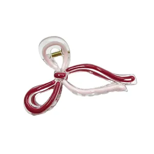 Elegant clear bow hair claw clip with pink and burgundy ribbon accents and metal spring
