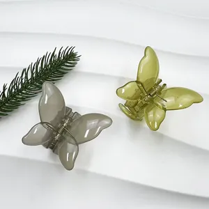 Pinces à cheveux papillon élégantes en gris foncé et vert olive sur support blanc