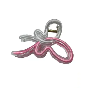 Pink butterfly hair claw clip with transparent acrylic wings and golden metal spring