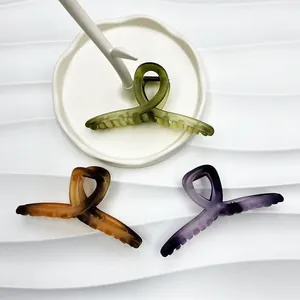 Three gradient 13cm matte hair claw clips in green, amber, and purple on a white display