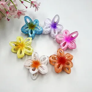 Close-up of six colorful gradient plumeria hair claws in high-quality resin material