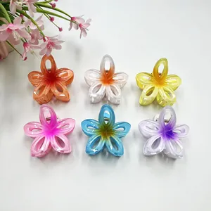 Detailed top view of six colorful hollow-out frangipani hair claw clips in matte finish