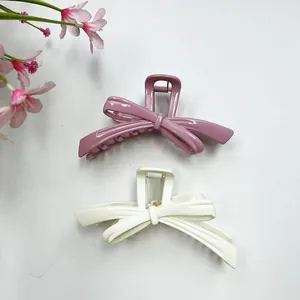 Set of two large elegant bow hair claws in matte pink and cream white colors